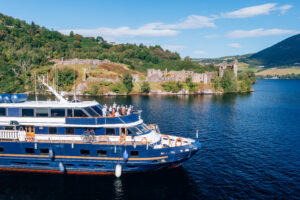 Guests on the bow of Lord of the Glens viewing Urquhart Castle on Loch Ness